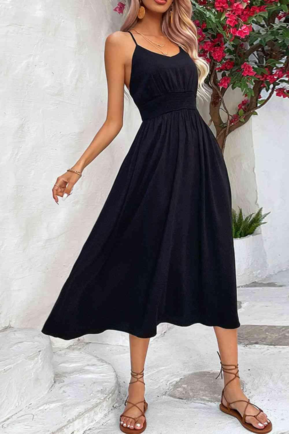a woman wearing a black dress and sandals