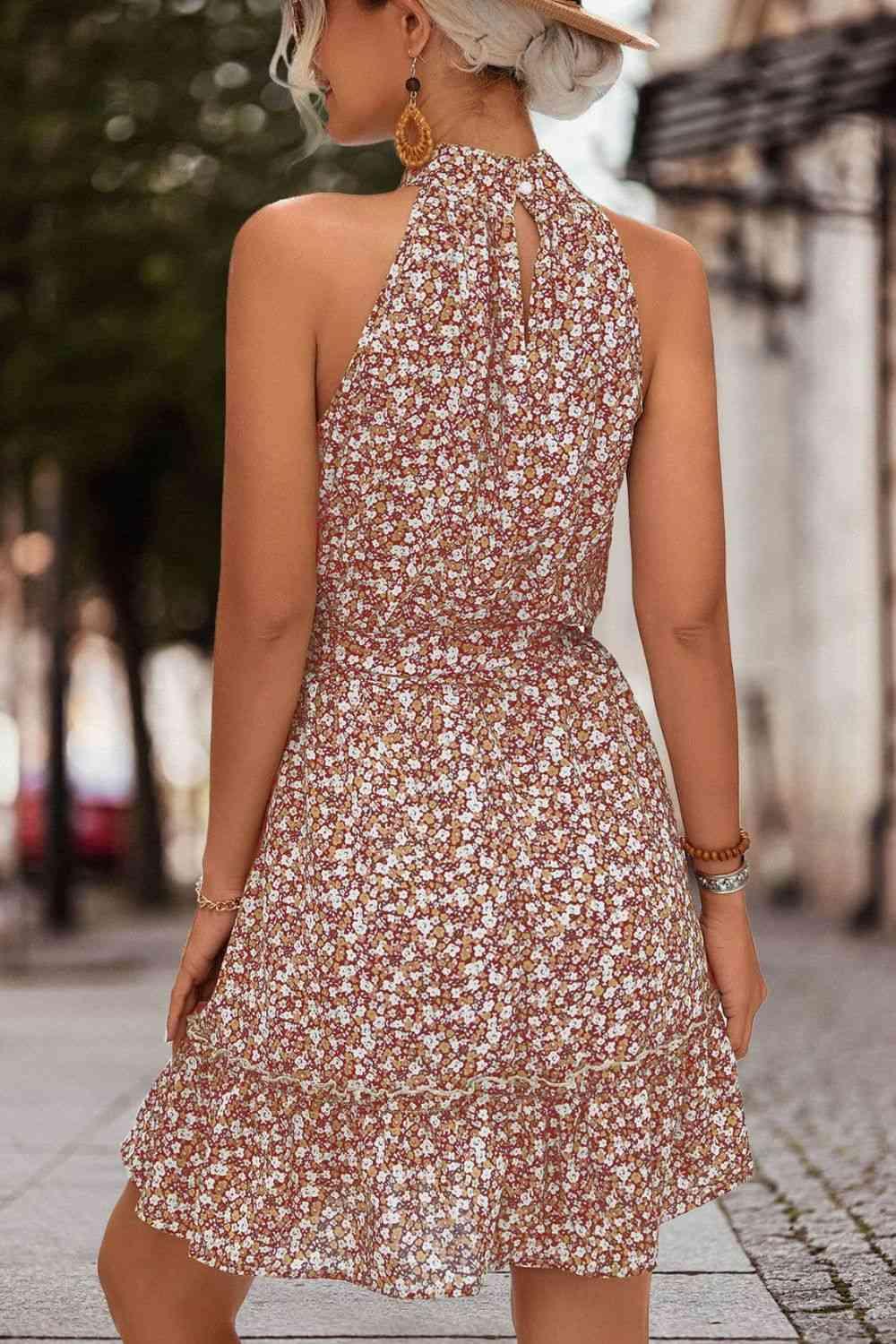 a woman in a dress and hat walking down the street