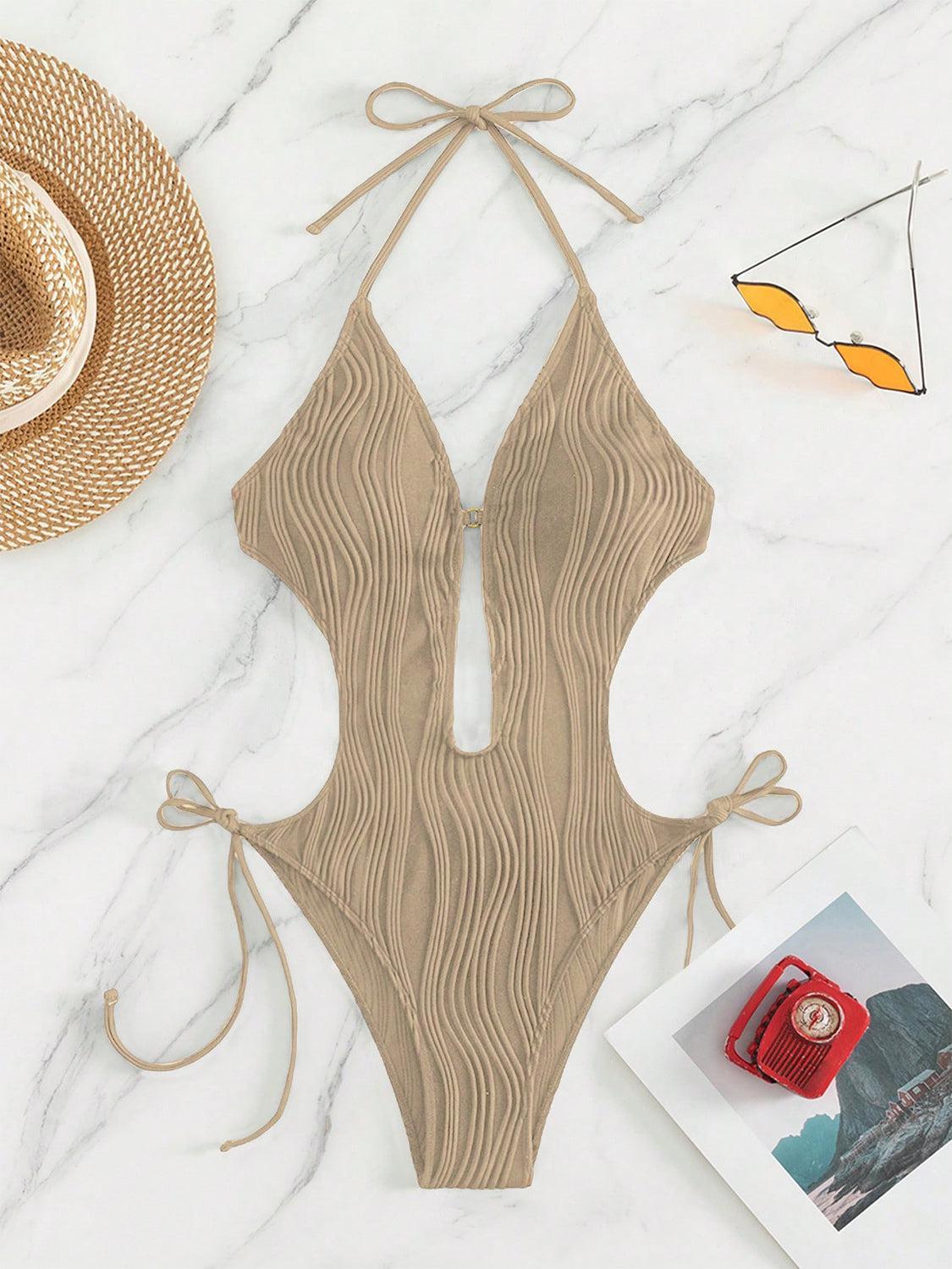 a bathing suit and hat on a marble surface