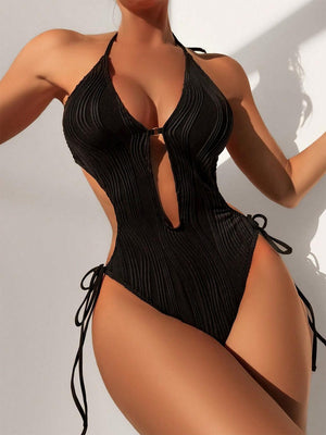 a woman in a black swimsuit posing for a picture