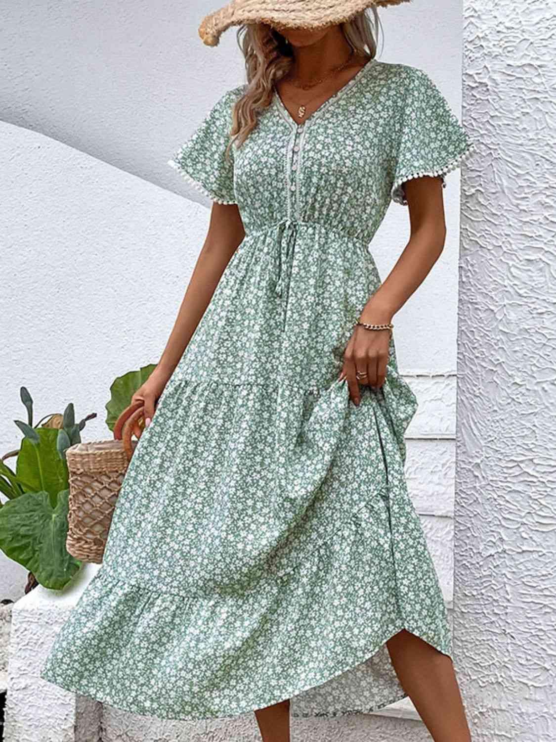 a woman wearing a green dress and a straw hat