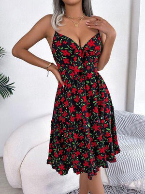 a woman wearing a black and red floral dress