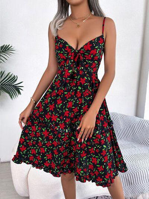 a woman wearing a black and red floral dress