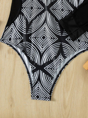 a women's swimsuit with a black and white pattern