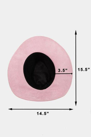 a pink cat bed with a black hat on top of it