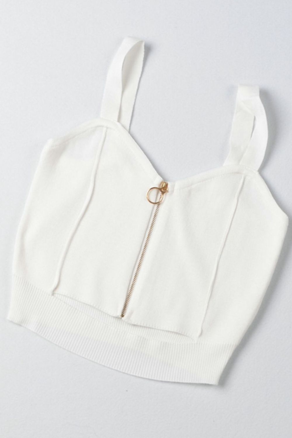 a white crop top with a zipper on it