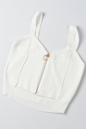 a white crop top with a zipper on it