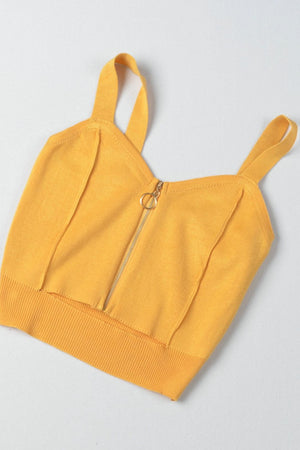 a yellow crop top with a zipper on the back