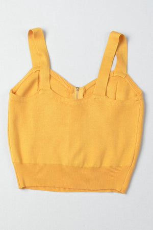 a yellow crop top with straps on the back