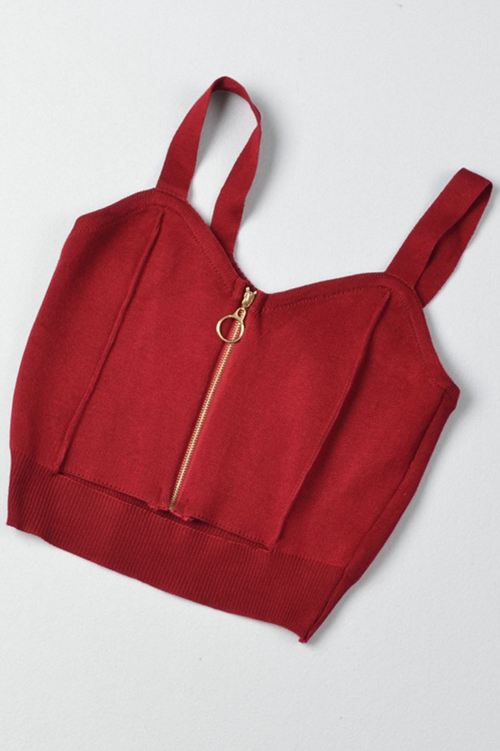 a red crop top with a zipper on the front