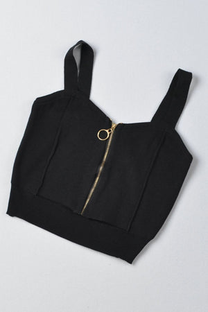 a black crop top with a gold zipper