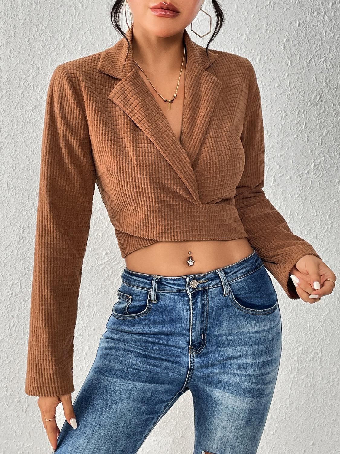 a woman wearing a brown top and jeans