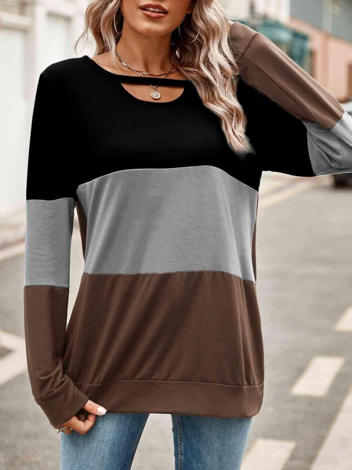 a woman wearing a brown and black top