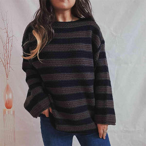 a woman wearing a black and grey striped sweater