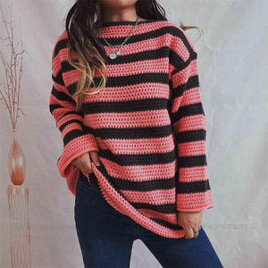 a woman wearing a pink and black striped sweater