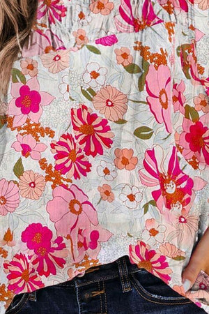 a close up of a person wearing a floral top