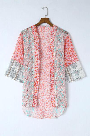 an orange and white shirt hanging on a wooden hanger