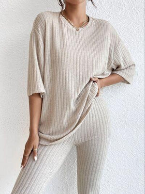 a woman in a sweater and pants posing for a picture