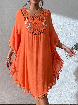 a woman in an orange dress posing for a picture