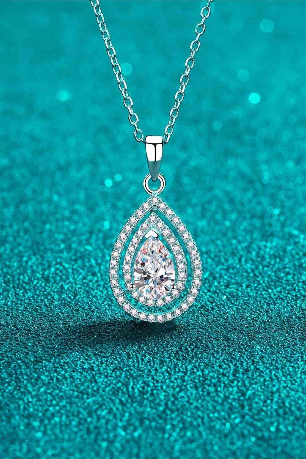 a necklace with a tear shaped diamond on it