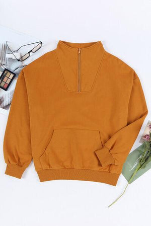 a brown sweatshirt with a flower and a pair of glasses