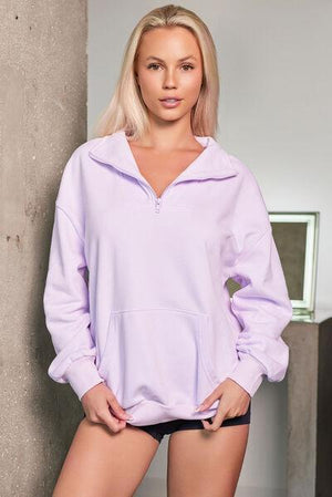 a woman in a purple hoodie posing for a picture
