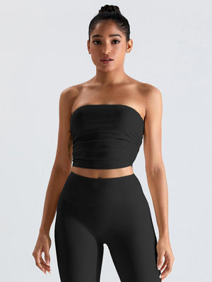 a woman in a black top and leggings