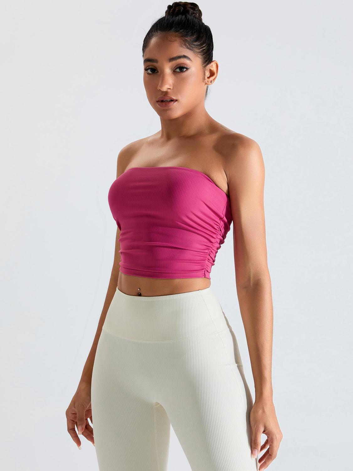 a woman in white pants and a pink top