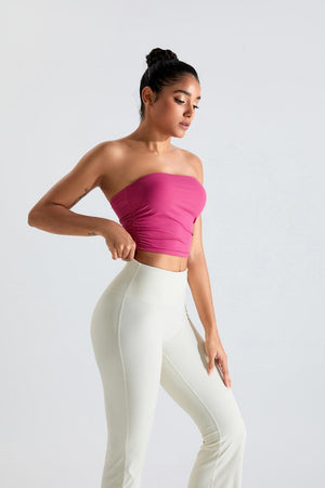 a woman in a pink top and white pants