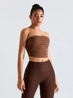 a woman in a brown top and leggings