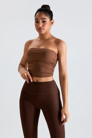 a woman in a brown top and brown leggings