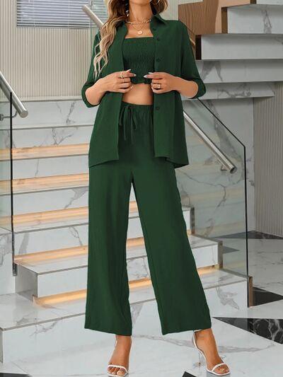 a woman in a green outfit standing in front of stairs