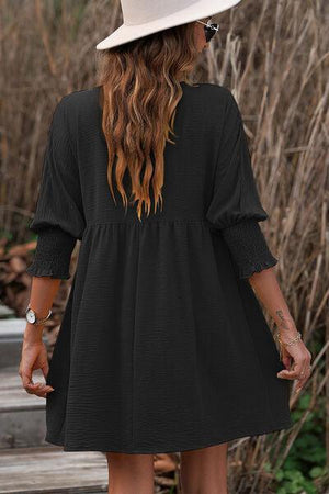 a woman wearing a white hat and black dress