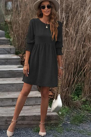 a woman in a hat and dress posing for a picture