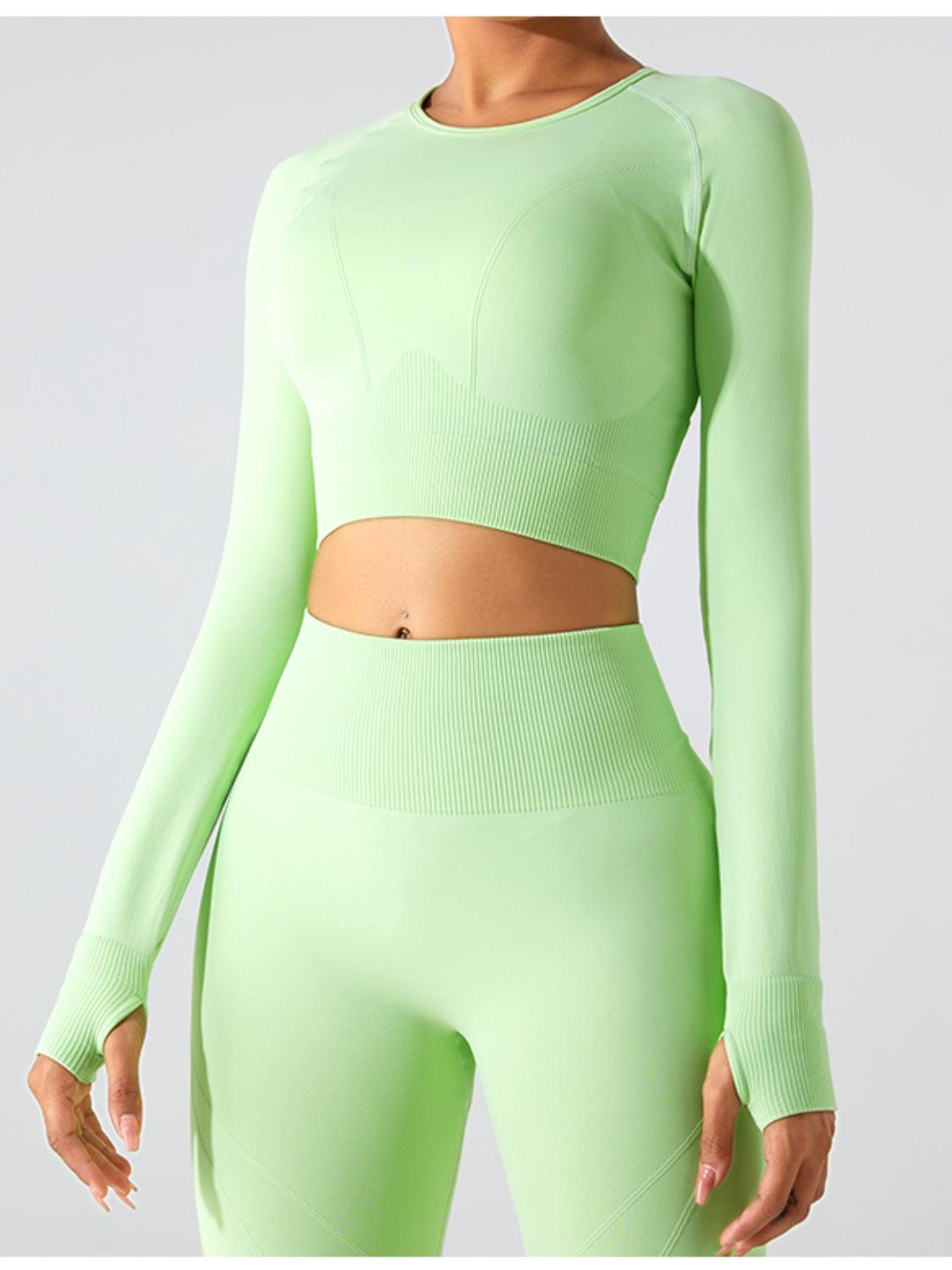 a woman in a green crop top and leggings