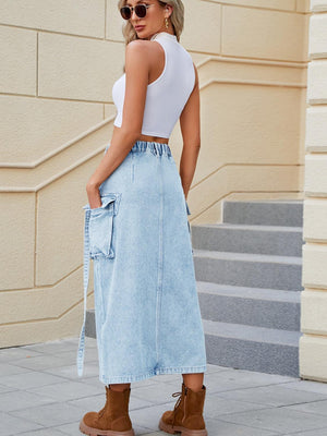 a woman wearing a white top and a denim skirt