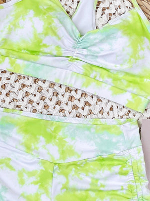 a green and white tie dye top and shorts