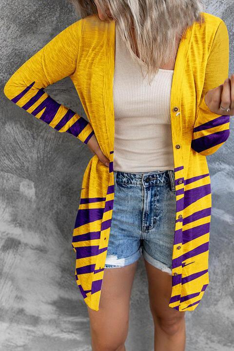 a woman wearing a yellow and purple striped cardigan