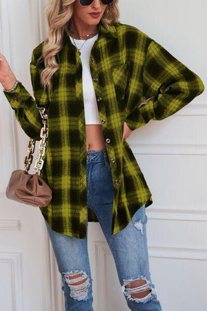 a woman wearing a green plaid shirt and ripped jeans