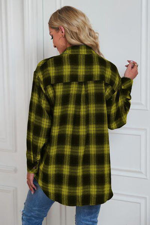 a woman wearing a green and black plaid shirt