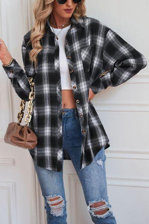 a woman wearing a black and white plaid shirt