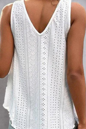 a woman wearing a white top with holes on it