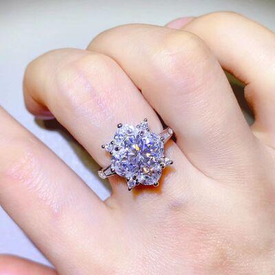 a close up of a person's hand with a ring on it