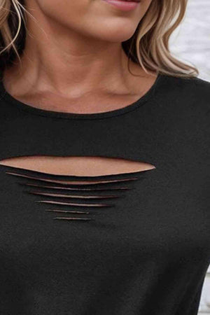 a woman wearing a black top with cut out shoulders