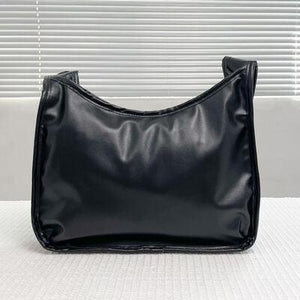 a black purse sitting on top of a white table