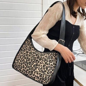 a woman is holding a leopard print purse
