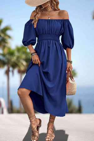 a woman wearing a blue dress and a straw hat