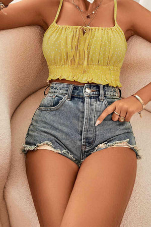 a woman sitting on a couch wearing a yellow top