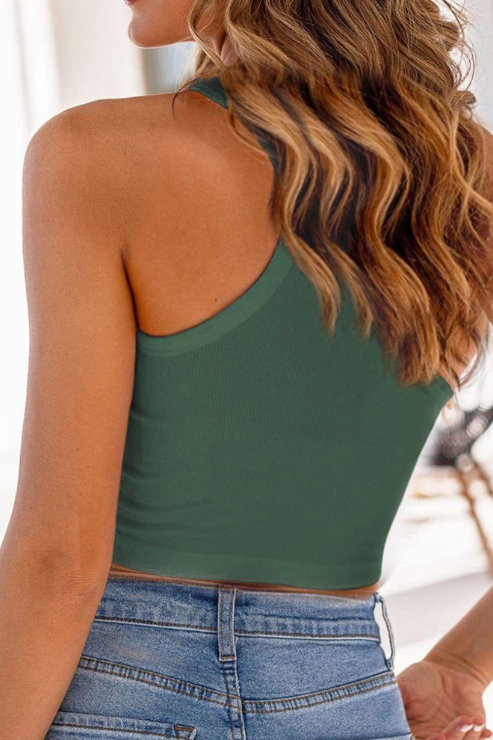 a woman wearing a green top and jeans