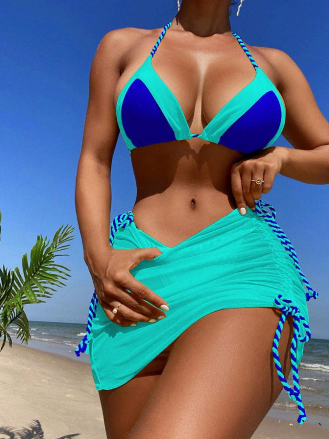 a woman in a blue bikini on the beach